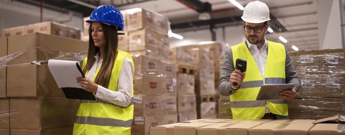 Warehouse-workers-using-bar-code-scanner-tablet-checking-goods-inventory